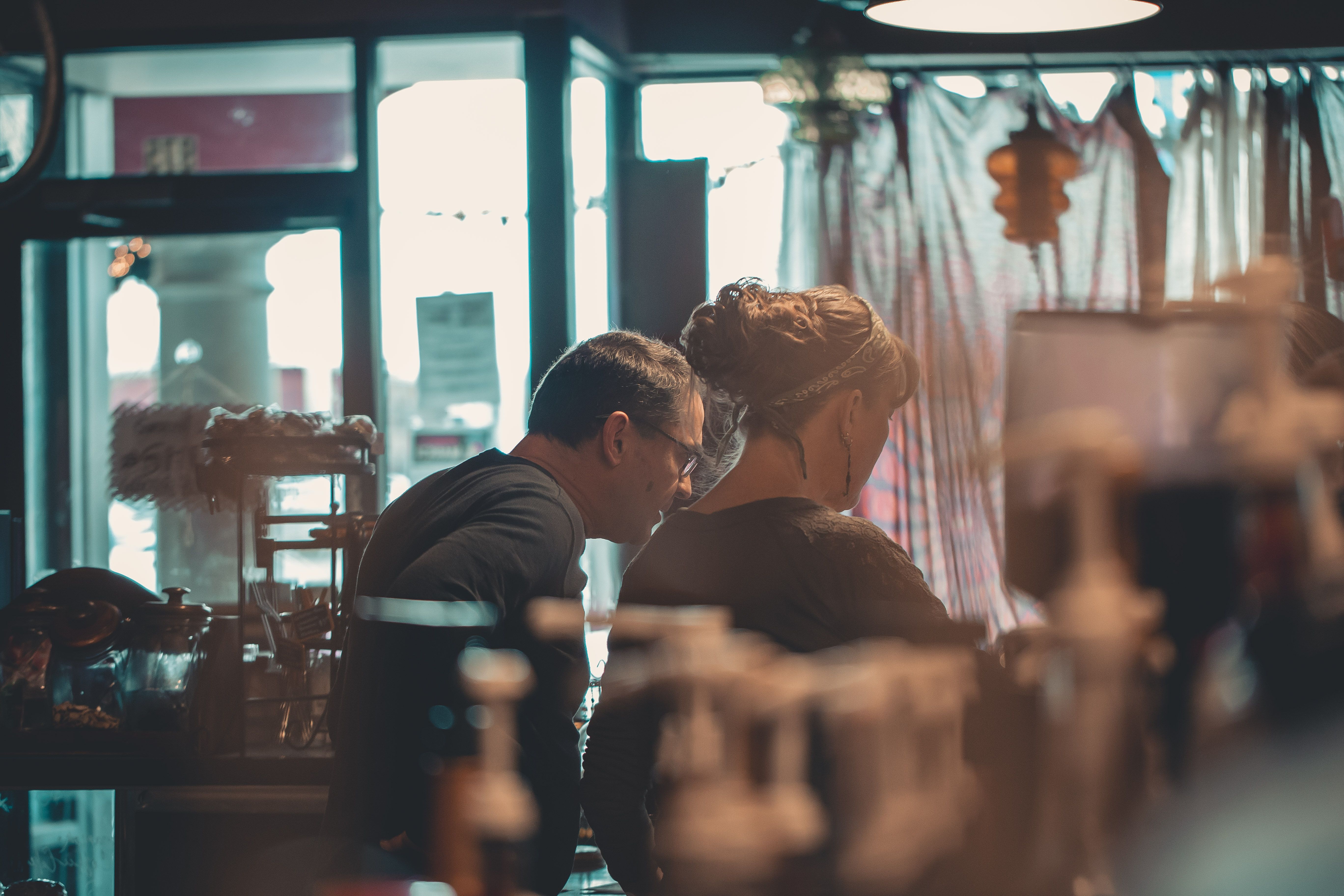 Two people in conversation in a shop — illustrative photograph